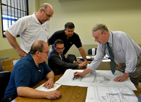 The Site Planning Review Committee meets regarding the Market Basket site on Federal Street at Lynn City Hall. James Moore of Bradley Moore Primason Cuffe & Weber LLP, describes the site plan to Robert Stilian, James Cowdell, Clint Muche and Jamie Marsh.