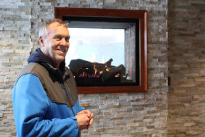 Richard F. Sullivan shows off the two-sided fireplace in his new burger restaurant, R.F. O’Sullivan’s, on Central Avenue in Lynn that is scheduled to open in less than a month