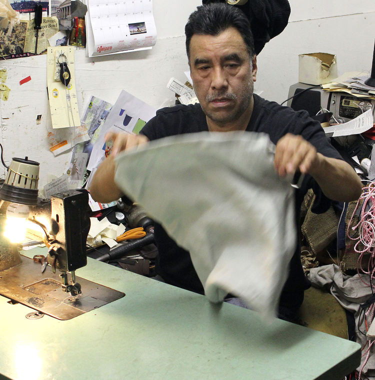  the main stitcher at F&J Leather Inc. of Lynn, makes a bag.