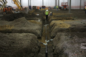 Workmen install drains in what will be the production area of the new Kettle Cuisine Company located next to the Clock Tower building in Lynn. 