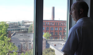 EDIC/Lynn Executive Director James M. Cowdell looks out the window of one of the top-floor apartments at 33 Central Square