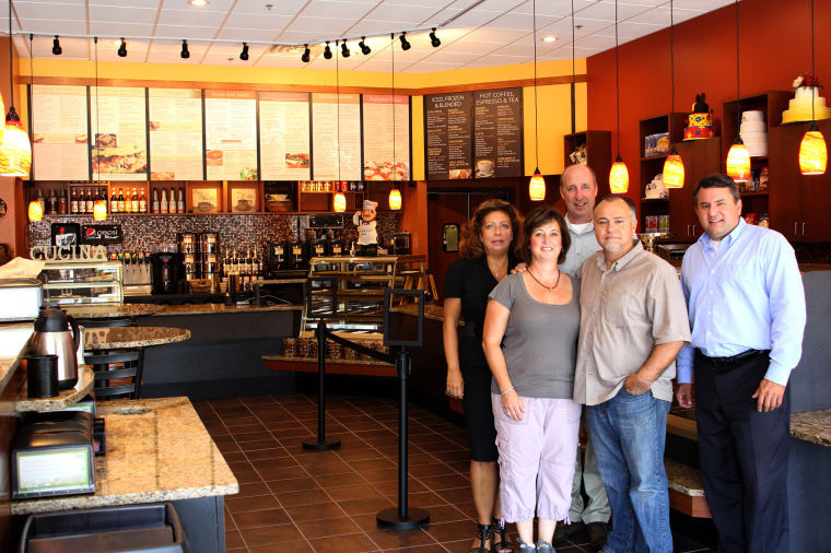 Inside the new D’Amici’s Downtown Lynn Café on Sutton Street are, back from left, Maryjane Smalley and James Cowdell of the Lynn Economic Development and Industrial Corp.; and front from left, owners Sarah Torretta and Joeseph Torretta, and Lynn Community Development Director James Marsh.